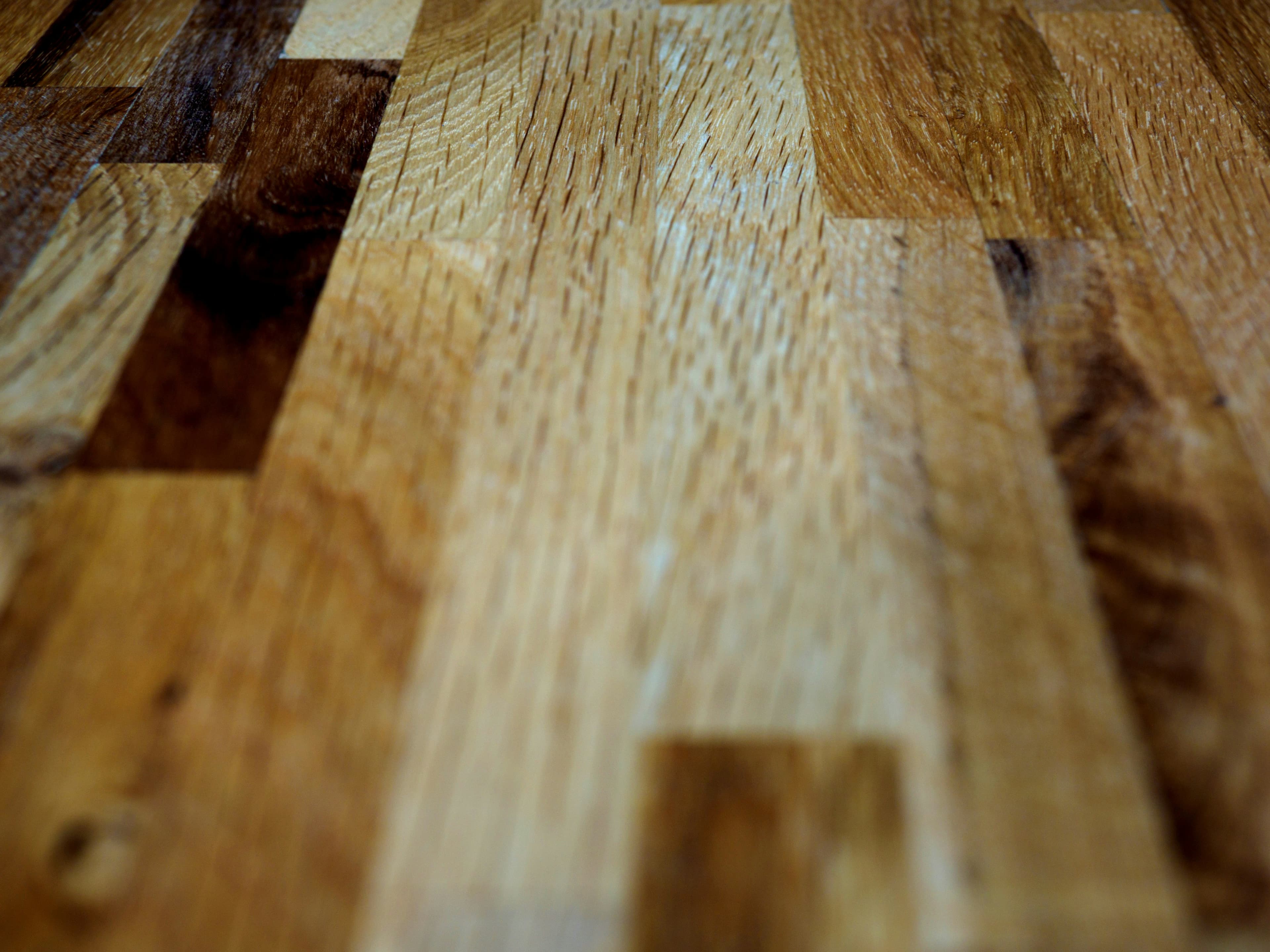 Engineered oak floor planks photographed in raking light, showing grain and joinery.